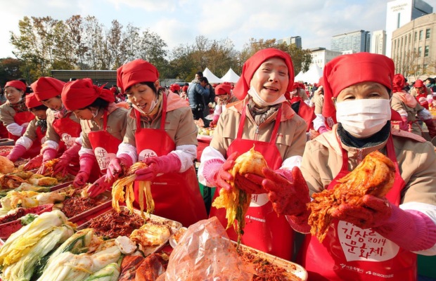 C&aacute;c nghệ nh&acirc;n v&agrave; du kh&aacute;ch c&ugrave;ng nhau thực hiện nghi thức muối Kim chi tập thể