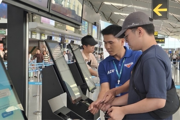 Nh&acirc;n vi&ecirc;n hướng dẫn h&agrave;nh kh&aacute;ch qu&eacute;t m&atilde; QR tại s&acirc;n bay Đ&agrave; Nẵng
