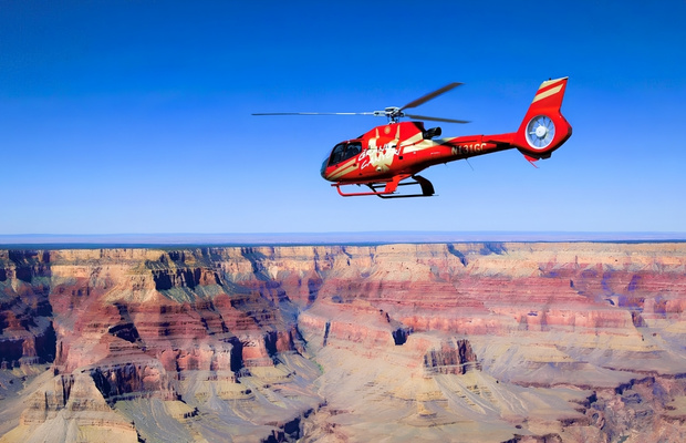 Trực thăng bay qua hẻm n&uacute;i Grand Canyon với khung cảnh thi&ecirc;n nhi&ecirc;n h&ugrave;ng vĩ b&ecirc;n dưới 